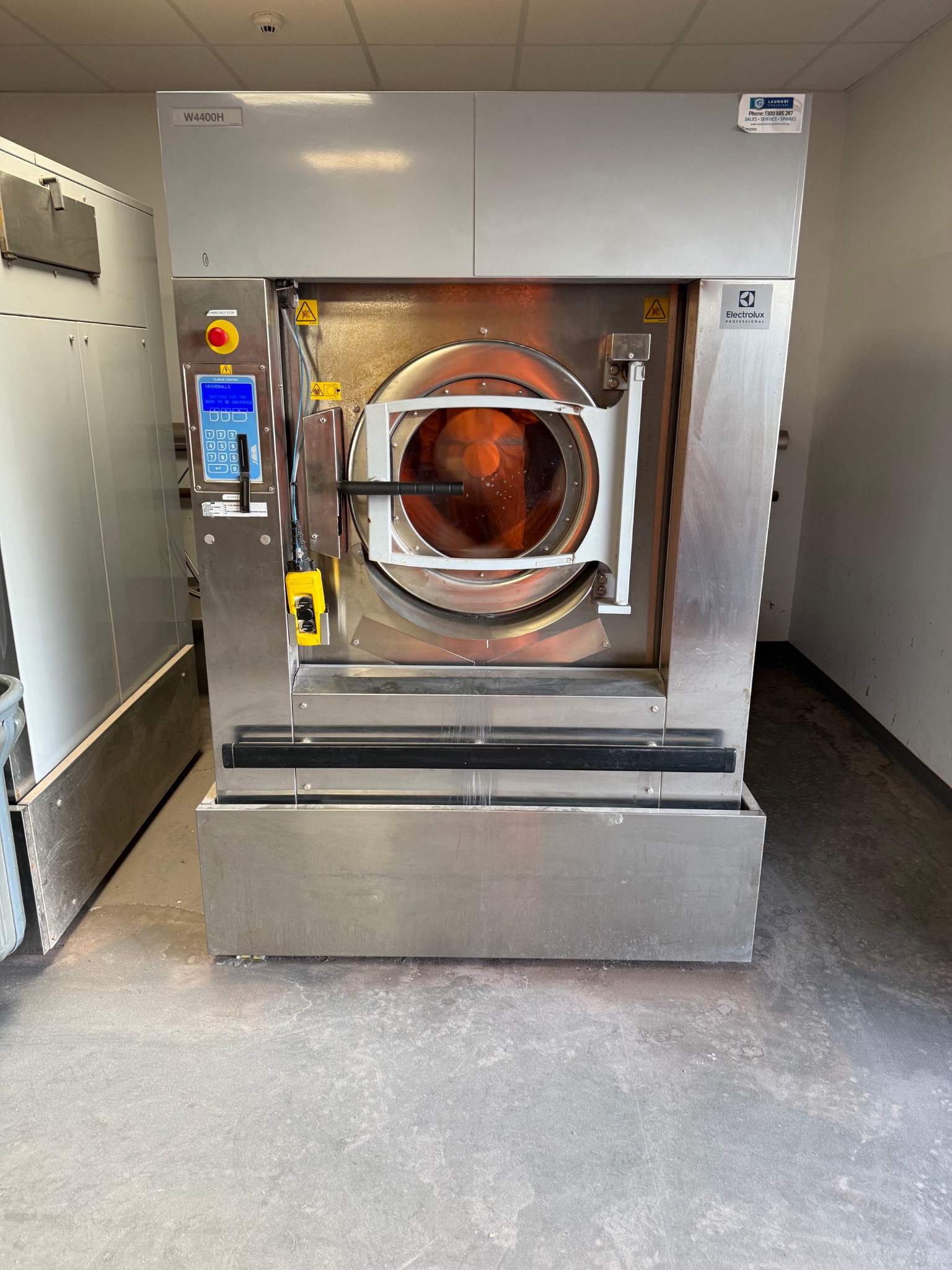 Installed high-capacity heavy-duty washer extractor with door open
